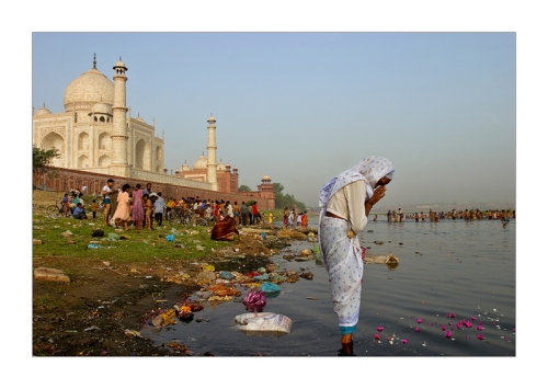 Woman praying behind Taj